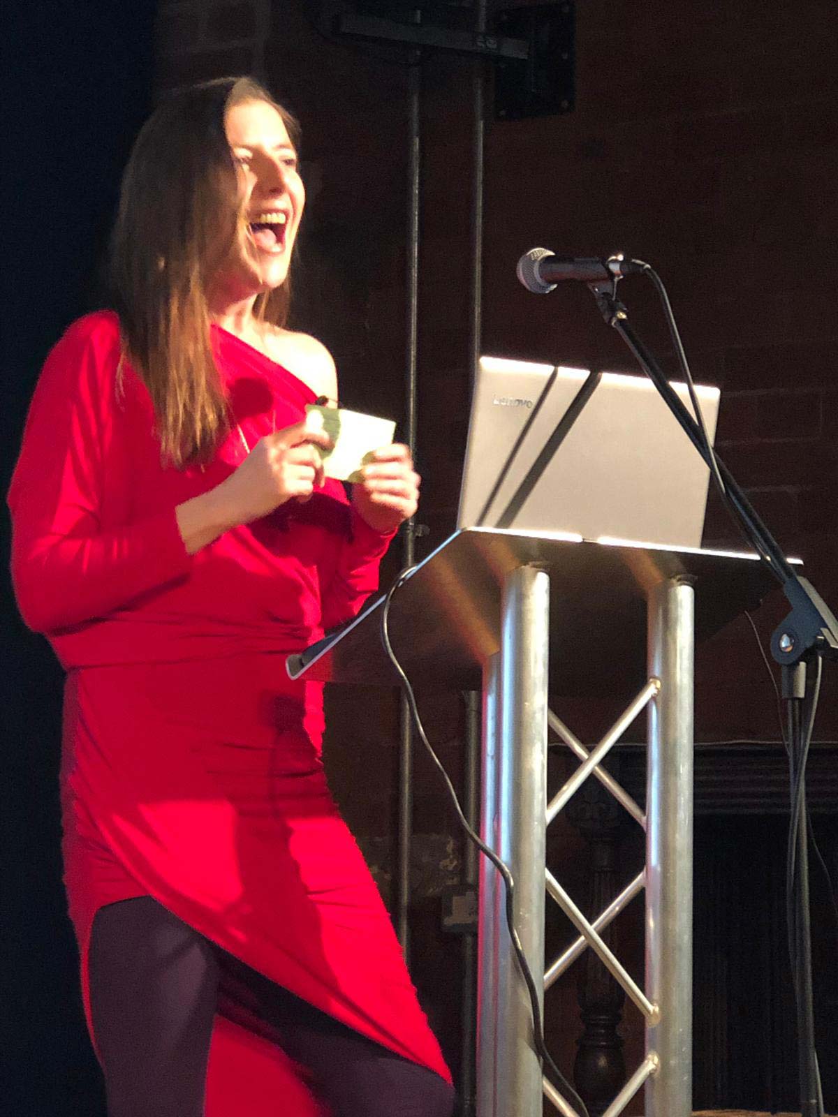 Sexologist, Sarah Rose Bright speaking in red dress